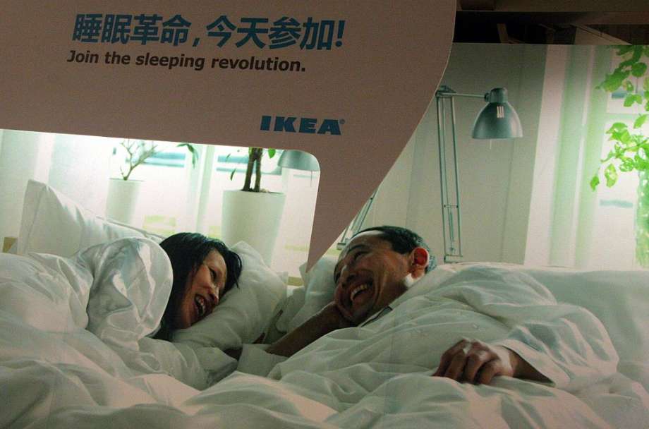 Shoppers test a bed at Ikealand in Shanghai. In China, IKEA is not only a place for shopping but also place to play. go on dates, and even sleep. Photo: Getty Images, Olivier Chouchana/Gamma-Rapho / 2011 Gamma-Rapho