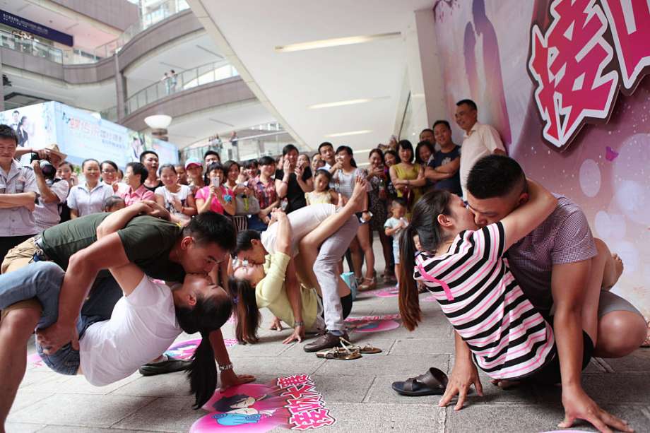 In Chongqing, 20 couples compete in a kissing contest at the New Century Department Store in Yongchuan Shopping Center. The winning couple beat others with 56 minute of kissing in seven rounds with different postures. Photo: Getty Images, Visual China Group / 2015 Visual China Group