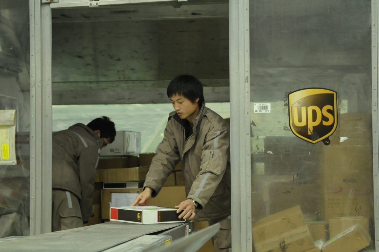 Staff loading a UPS aircraft container in Shanghai China bound for export