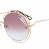 carlina sunglasses with light gold frame and artistic print on burgundy lenses